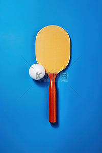球赛背景图片_蓝色表面上的乒乓球棒和球