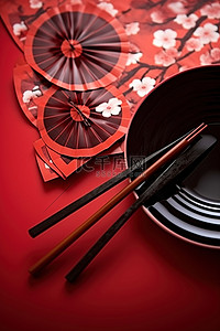 红色背景中的筷子板和风扇