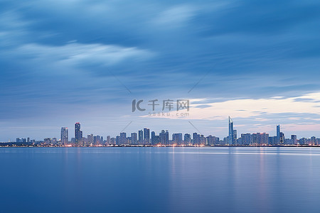 云中的城市背景图片_漂浮在大片水域中的孤独城市天际线