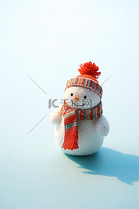 小红书主图背景图片_蓝色表面戴着红白羊毛帽的小雪人