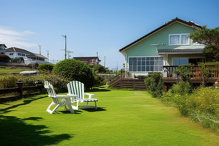 草坪背景图片_院子里的房子有草坪木制甲板和躺椅