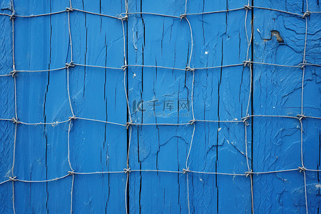 铁丝背景背景图片_一堵旧的蓝色木墙，上面覆盖着铁丝