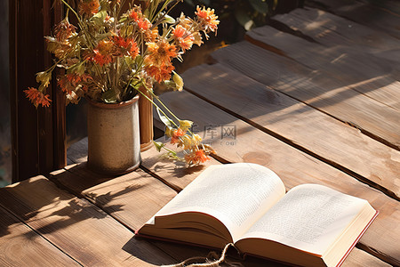 质朴的花背景图片_一本打开的书放在一张质朴的木桌上