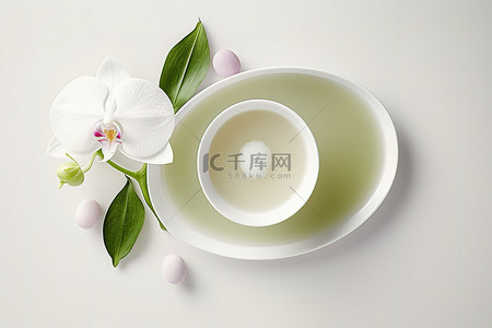浴背景图片_碗里的热绿茶和白兰花