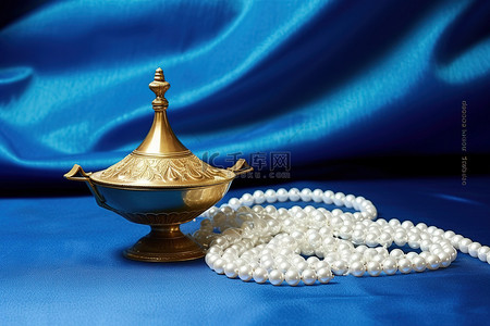 工具蓝色背景图片_靛蓝背景上的珍珠和一盏小灯