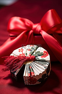 婚礼展背景图片_带着礼物和红丝带的扇子