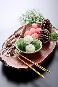 筷子传统背景图片_甜点和糖果用筷子和松果