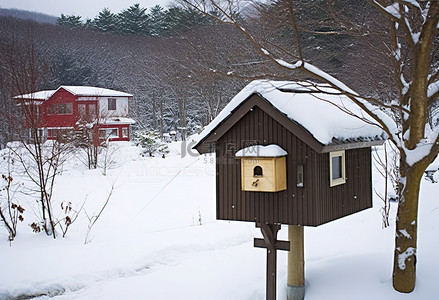邮箱背景图片_邮箱位于一座被雪覆盖的小房子的前面