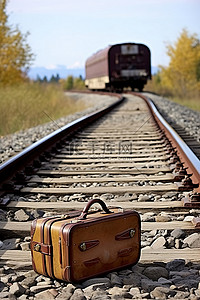 公路铁路背景图片_手提箱坐在乡村公路旁的铁轨上