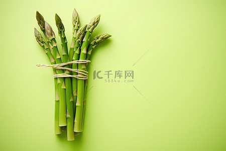 周二素食日背景图片_浅黄色上孤立的绿芦笋