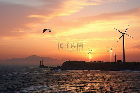 滑翔伞手绘背景图片_日落时，一个人在海洋附近的风车上滑翔