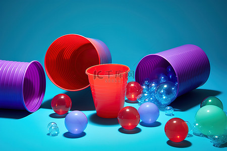 星星粒子背景图片_一个红色的球，周围有几个塑料杯