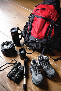 背包画册背景图片_木桌上放着一个包相机和登山靴
