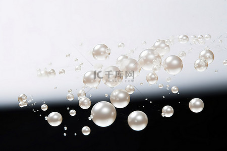 粒子消散字幕背景图片_浅色背景中漂浮在空中的几颗珍珠