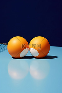 蓝桌上的两个橙色乒乓蛋