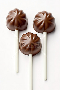 白色巧克力背景图片_白色背景下的三个白色巧克力棒棒糖