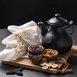 黑茶壶背景图片_茶壶黑布和一些干果