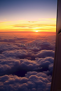 看日出背景图片_日落在云层上看着飞机窗外