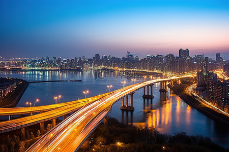 江边日落背景图片_朝鲜半岛空中公路桥场景傍晚日出城市景观