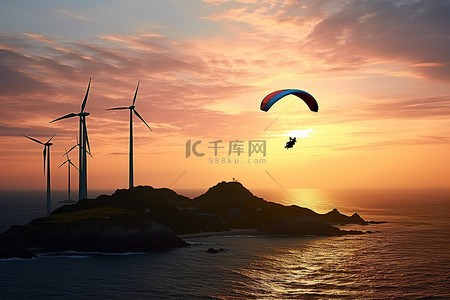 日落时，一个人在海洋附近的风车上滑翔