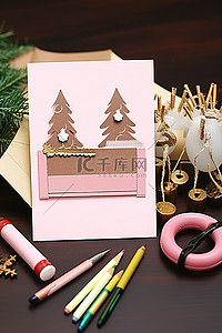 手工面晒面图背景图片_手工和装饰用品包括一张带有铅笔和笔架的圣诞快乐卡