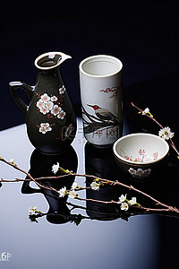 花卉樱花背景图片_黑色表面的日本花卉装饰和餐具