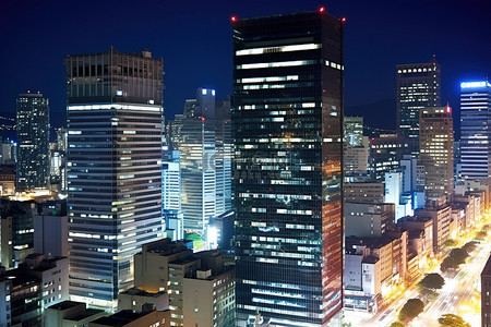 江中背景图片_夜晚前景中充满高楼大厦的城市