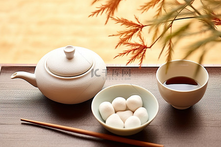 小碗旁边有一个带茶杯和筷子的白盘子