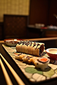 一片寿司和东方主题的桌子上的棍子