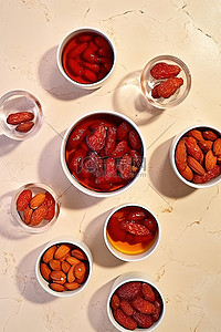 红糖姜枣枸杞茶背景图片_一张桌子，上面放着几杯枸杞和坚果