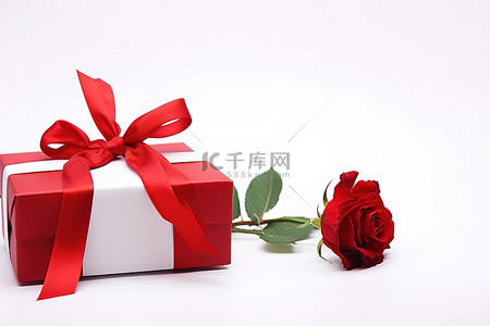 一朵红玫瑰和一个带丝带的礼品盒