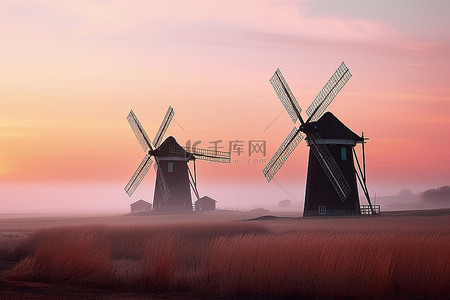 生态山景背景图片_日落时，两座风车矗立在草地上