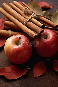 一捆木背景图片_一个苹果，一根肉桂棒和一些叶子