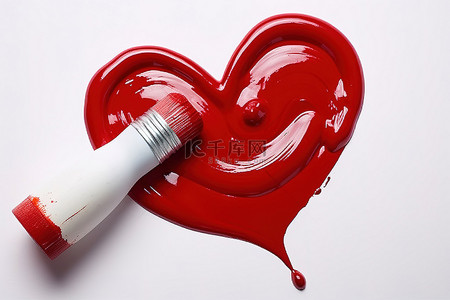 一个红色心形的红色食用色素和一个大的白色底漆刷