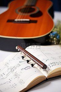 音乐中背景图片_音乐商业尤克里里琴中带笔的笔记本音乐躺在桌子上