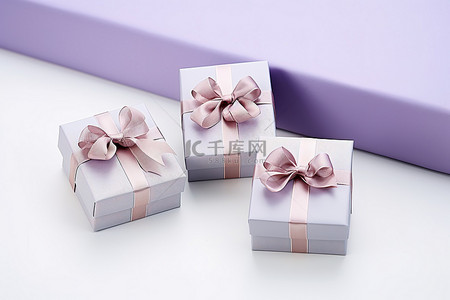 三个礼品盒塞进一个用紫色丝带包裹的袋子里
