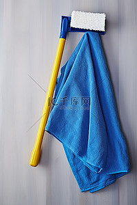 工具手柄背景图片_一个空的拖把手柄，上面有一块蓝色的布和一块黄色的拖把
