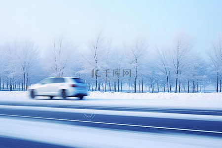 一辆小汽车在雪路上驶过几棵树