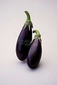 蔬菜免扣PNG图背景图片_两个茄子，一个在上面