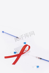 艾滋病日摄影照片_红丝带注射器艾滋病预防