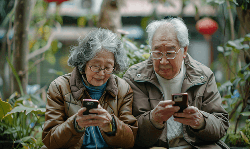 坚果手机摄影照片_亚洲人老年夫妇在庭院使用手机2