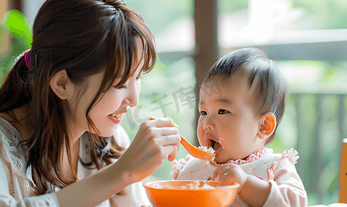 吃饭用品摄影照片_亚洲人妈妈给宝宝喂饭