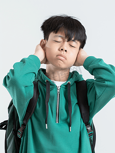 闭着眼睛摄影照片_亚洲人疲劳的中学生