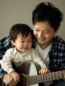 亚洲人父亲和男孩在弹吉他