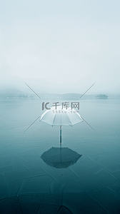 一把艾草背景图片_夏天蓝色水面上的一把透明的伞素材