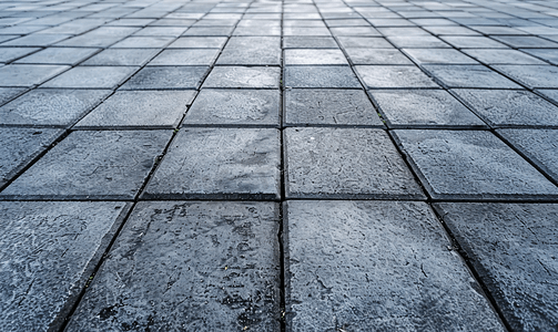 地板铺摄影照片_正方形形式的抽象背景灰色铺路板