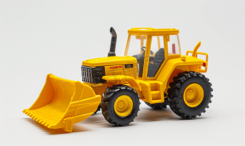 拖拉机的人摄影照片_白色背景隔离图像上的黄色拖拉机装载机玩具
