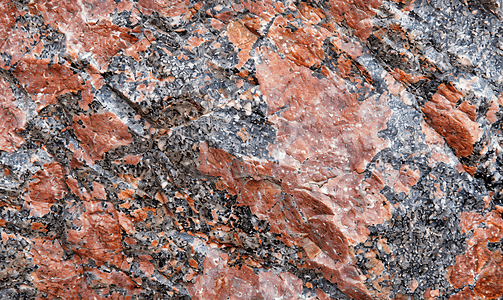 棕色海报摄影照片_灰红色花岗岩的美丽背景花岗岩石特写