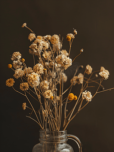 枯萎的花朵摄影照片_深棕色背景花瓶中枯萎的花朵