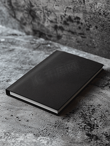灰色商务模板摄影照片_中性灰色混凝土背景上带有柔和阴影的空黑色笔记本模型